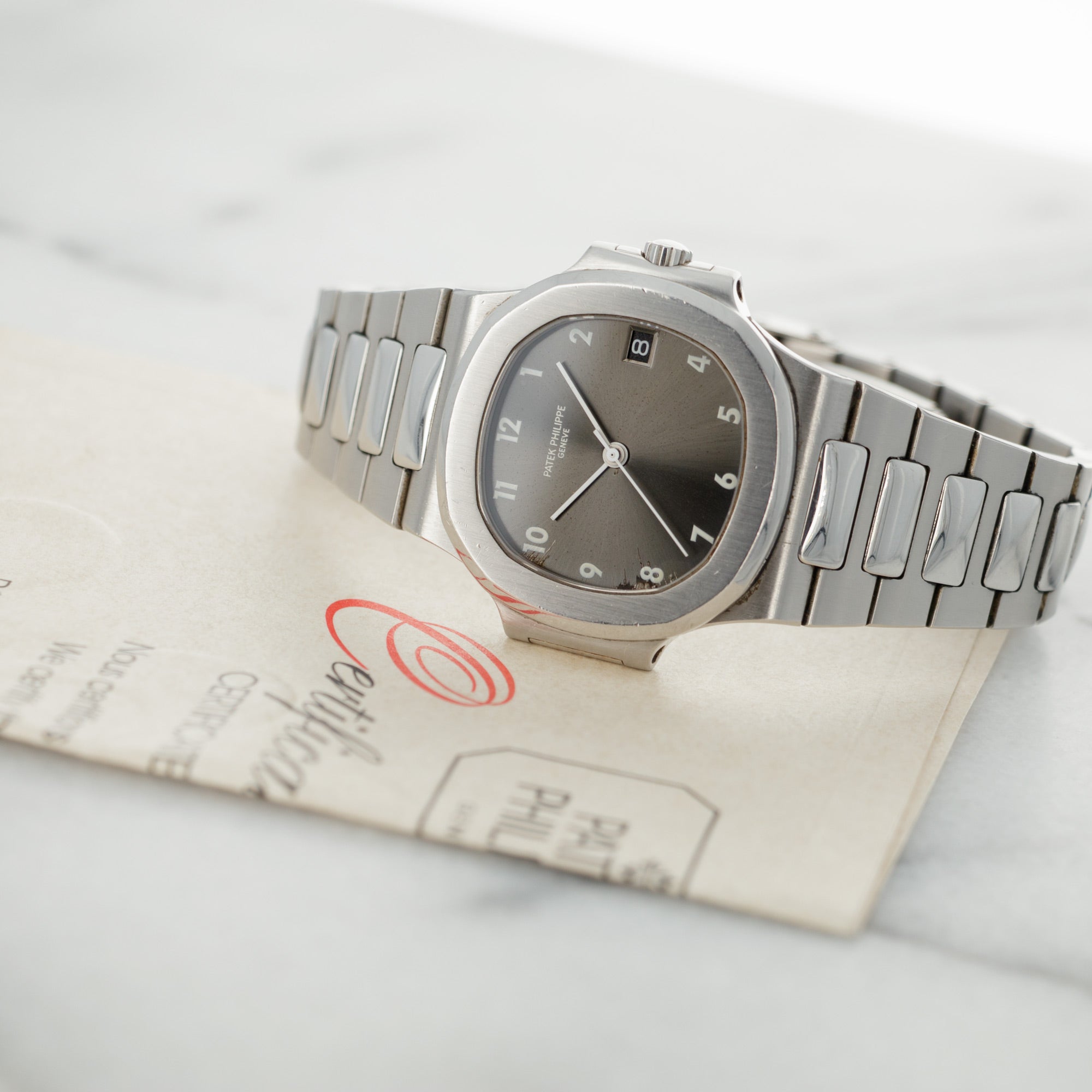 Patek Philippe Steel Nautilus Ref. 3800 with Rare Arabic Numeral Dial and Original Warranty