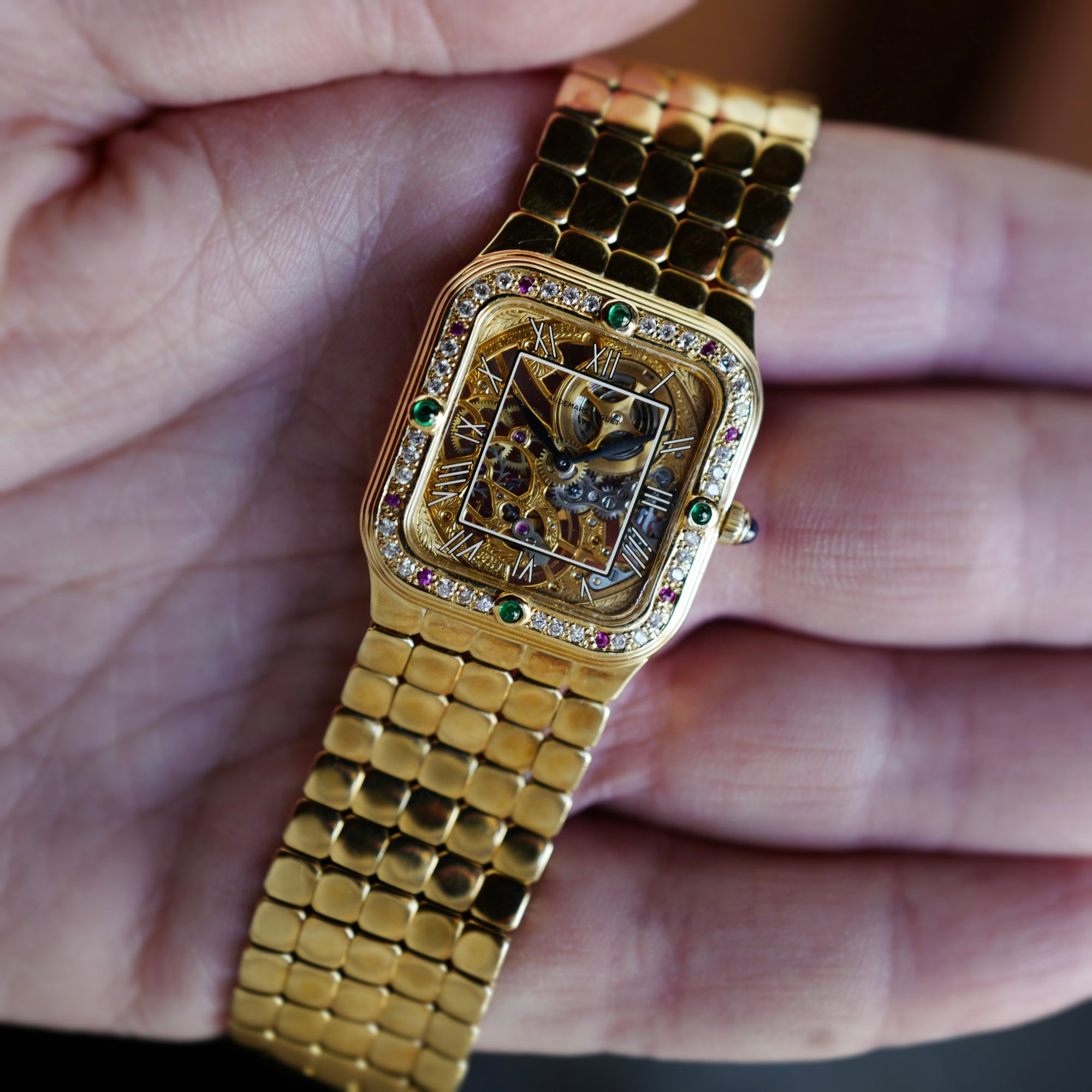 Audemars Piguet Yellow Gold Square Skeleton Watch with Diamonds, Emeralds and Rubies