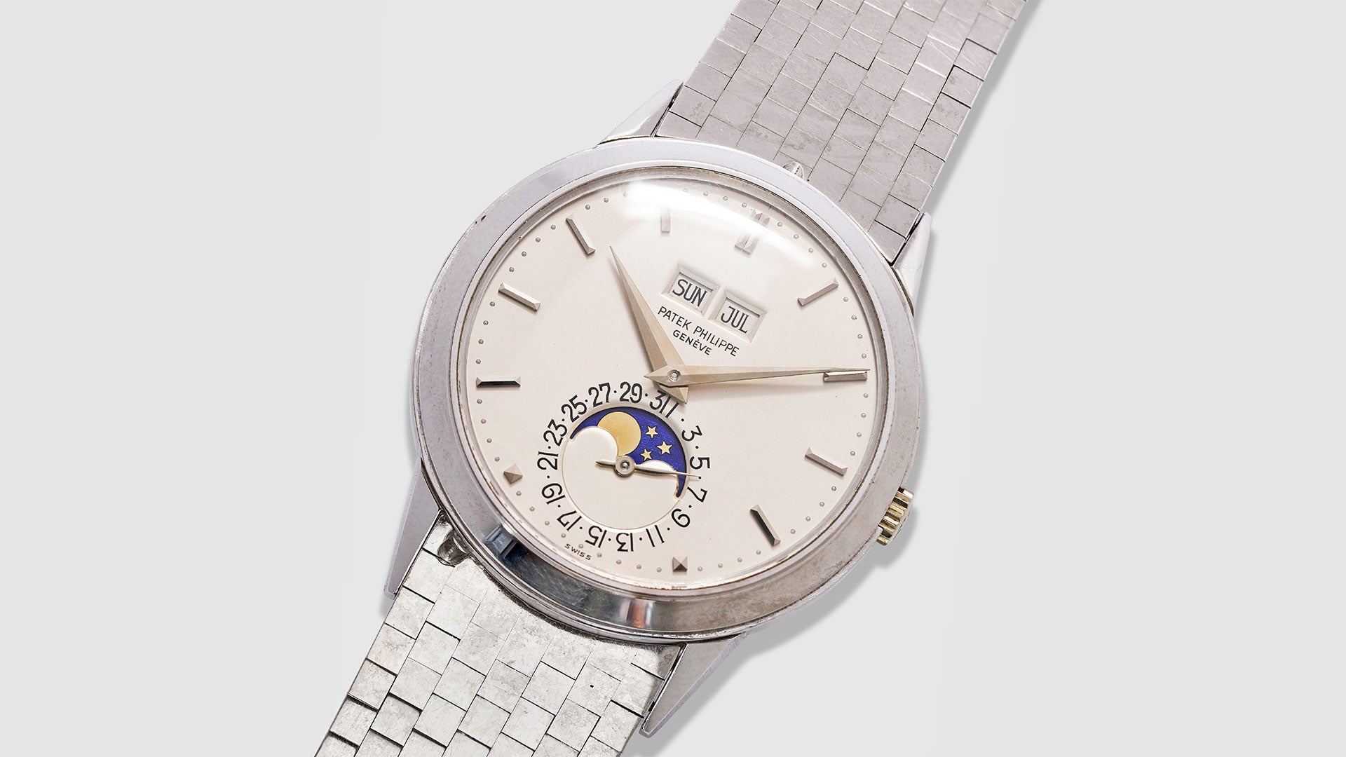 Vintage white Gold Patek Philippe Perpetual Calendar watch 3448 with bracelet on light background. 